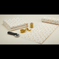 Garden of Dreams II Gold Buds 3-yard cut quilting cotton folded and partially unrolled on a sewing table with quilting tools