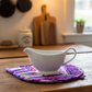Handmade Violet Jewel quilted leaf hot pad under a white ceramic gravy boat | IraRobi Quilts #handmadekitchen #hotpad #quilted