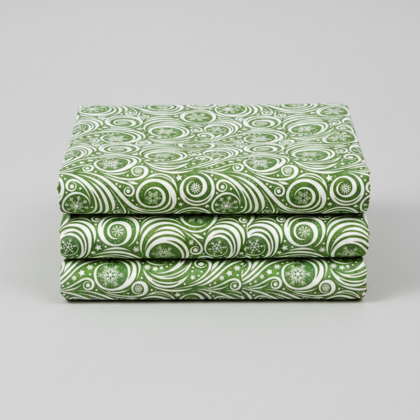 Winter Solstice II Green on White Snow Swirl quilting cotton by Jason Yenter for In The Beginning Fabrics — three folded yards stacked on a grey surface showing flowing white scroll swirls with snowflakes and scattered stars on mottled watercolor green. Quilt blocks shown for inspiration. Coordinating fabrics and quilt patterns are available at IraRobi Quilts.