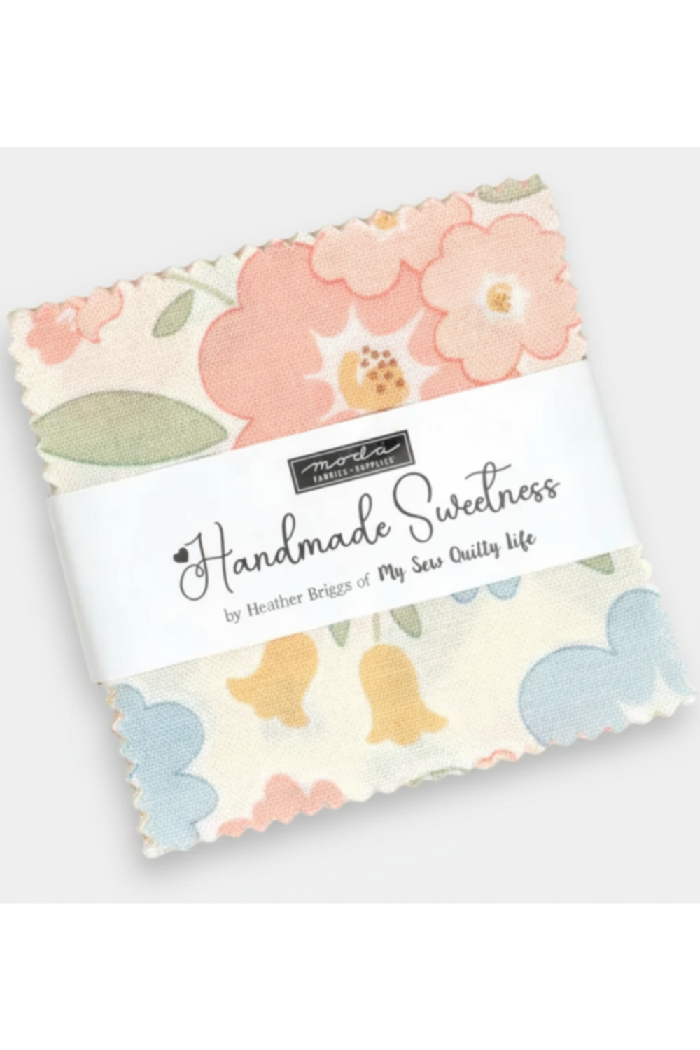 Handmade Sweetness Mini Charm Pack by Heather Briggs for Moda Fabrics – 42 pre-cut 2.5" x 2.5" cotton squares in blush pink, powder blue, butter yellow & sage green. Perfect for doll quilts, patchwork & table runners! #QuiltingFabric #MiniCharmPack #ModaFabrics #HandmadeSweetness #CottonFabric