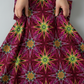 What If Radio Star Red/Multi quilting cotton gathered in hands showing fabric drape and texture — bold kaleidoscopic starburst by Paula Nadelstern for Benartex