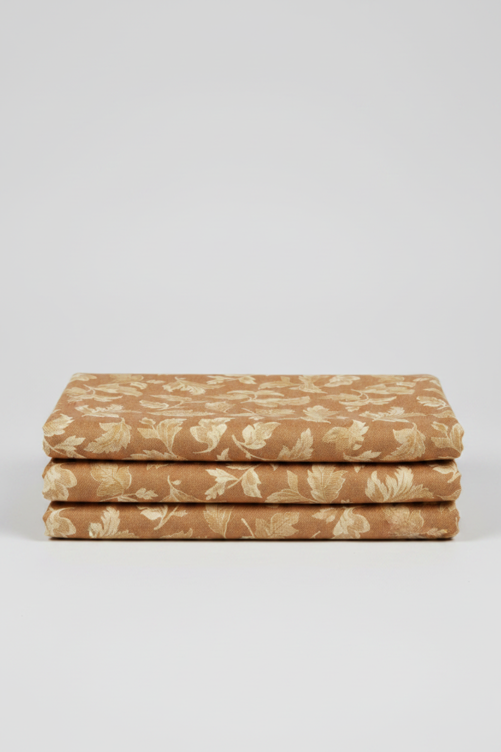 Front Porch Swing Rust by Dolores Smith for Marcus Fabrics — rust-amber quilting cotton with all-over scrolling acanthus and oak leaf motif in cream and gold, 100% cotton 43–44" wide — shop at IraRobi Quilts