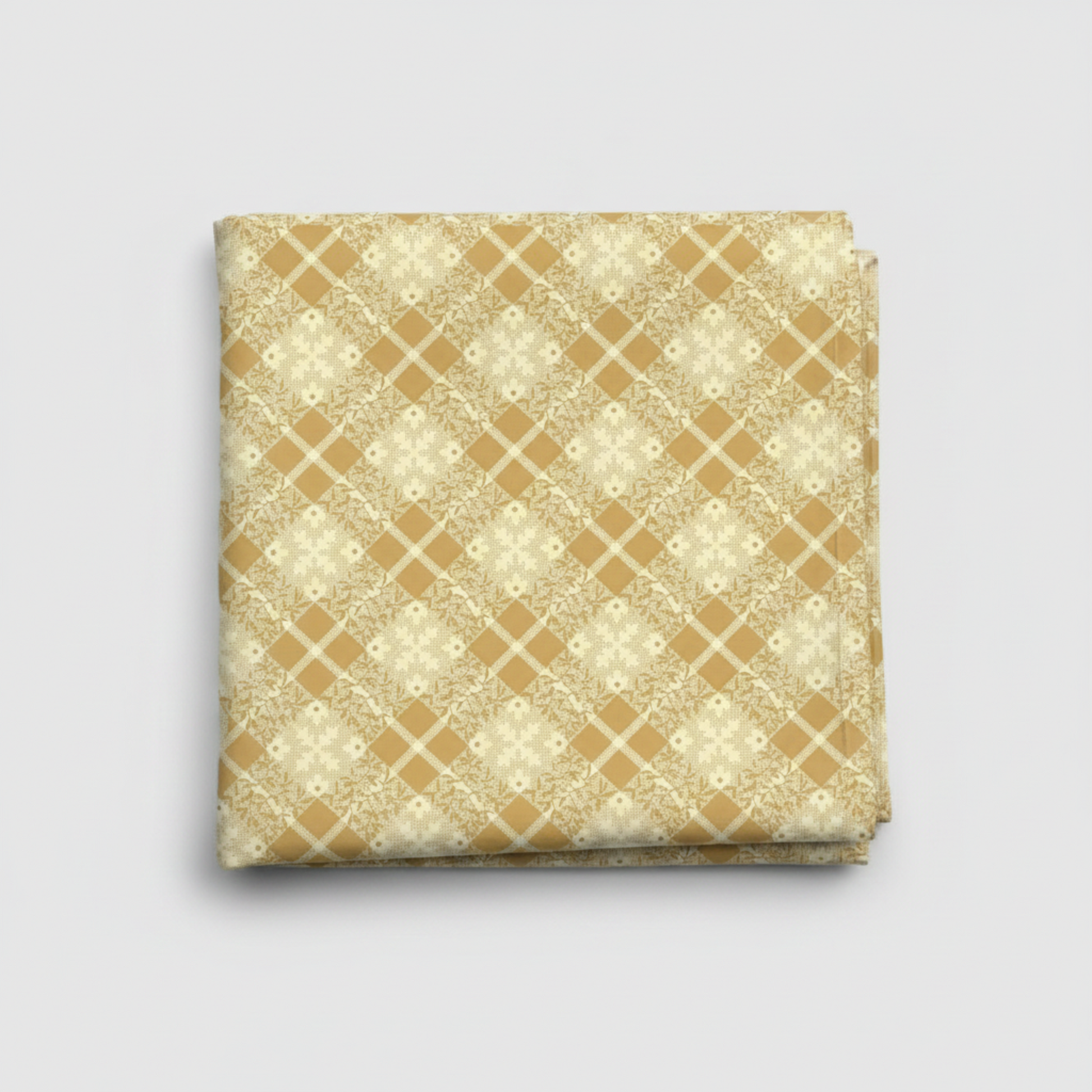 Golden Era by Paula Barnes, Floral Plaid Tan quilting cotton for Marcus Fabrics — neatly folded fabric showing warm tan-gold ground with diagonal lattice grid and delicate cream floral wreath motifs, 100% cotton 43–44" wide