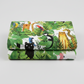 Safari Fun White/Multi quilting cotton neatly folded showing large-scale watercolor jungle print — lush tropical leaves with leopards, black panthers, monkeys, parrots, and toucans on white — Terry Runyan for Benartex | IraRobi Quilts