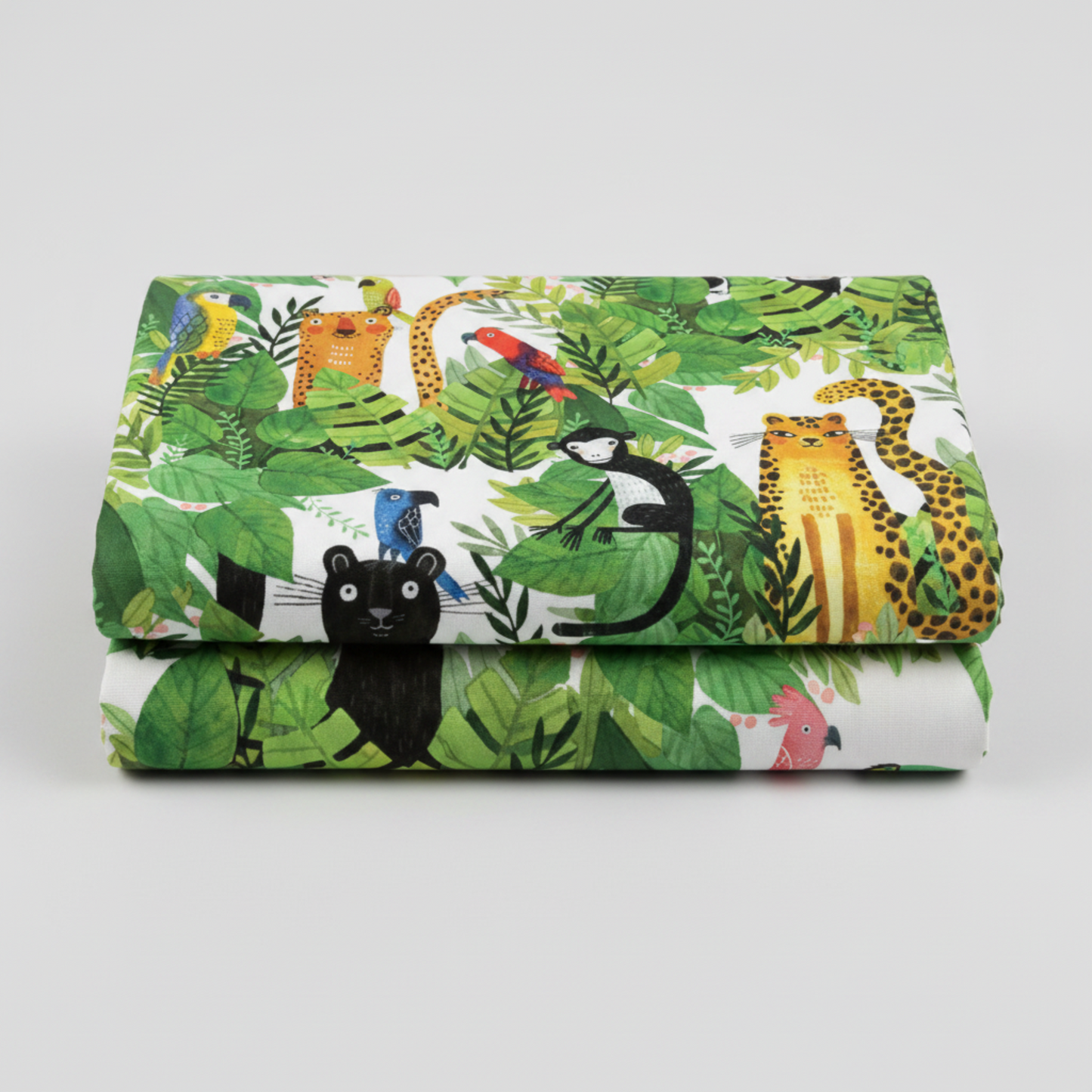 Safari Fun White/Multi quilting cotton neatly folded showing large-scale watercolor jungle print — lush tropical leaves with leopards, black panthers, monkeys, parrots, and toucans on white — Terry Runyan for Benartex | IraRobi Quilts
