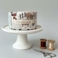 High Meadow Farm Jelly Roll by Lynette Anderson Designs displayed on white cake stand with appliqué scissors and wooden thread spools