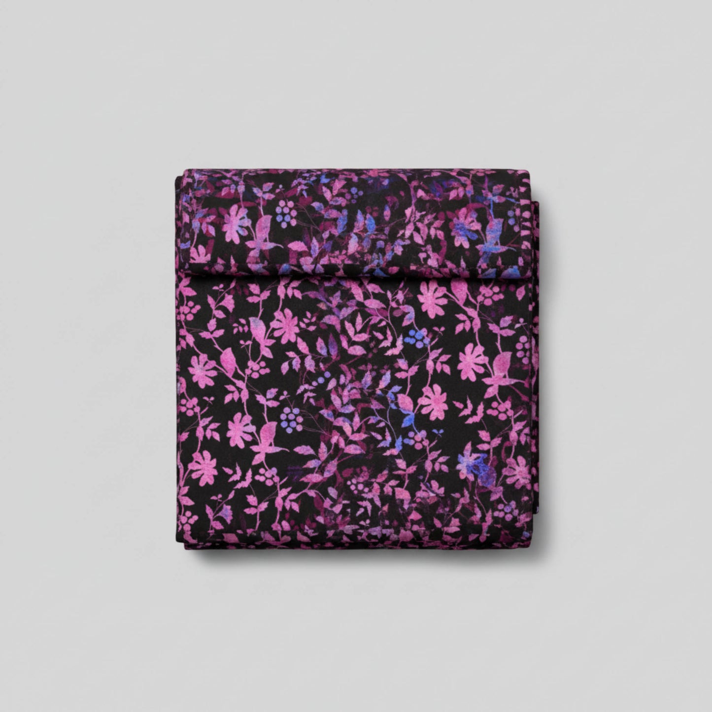 Halcyon II Magenta Vines fabric folded into 3-yard cut square showing pink, magenta, and blue botanical vine pattern on black cotton by Jason Yenter for In The Beginning Fabrics