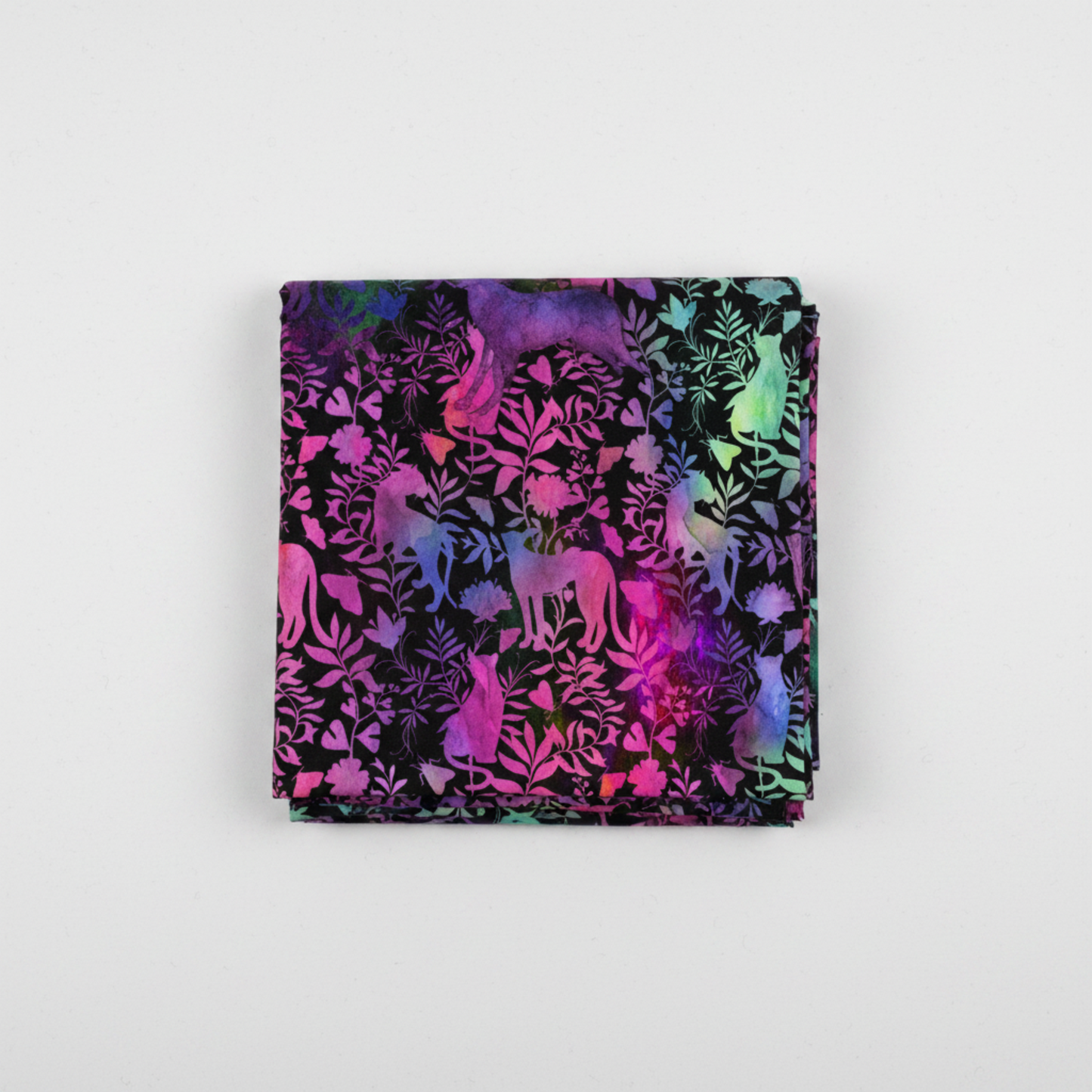 Impressions Jewel Jungle quilting cotton fabric folded to show allover animal silhouettes and botanical foliage – jewel-toned cats, dogs, and horses in hot pink, purple, teal, and lime green on deep black ground by Jason Yenter for In The Beginning Fabrics, 100% cotton, 3 yard cut