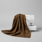 Interwoven Brown Fabric by Jason Yenter for In The Beginning Fabrics draped naturally over a sewing machine with soft folds showing the rich deep brown geometric crosshatch print and texture