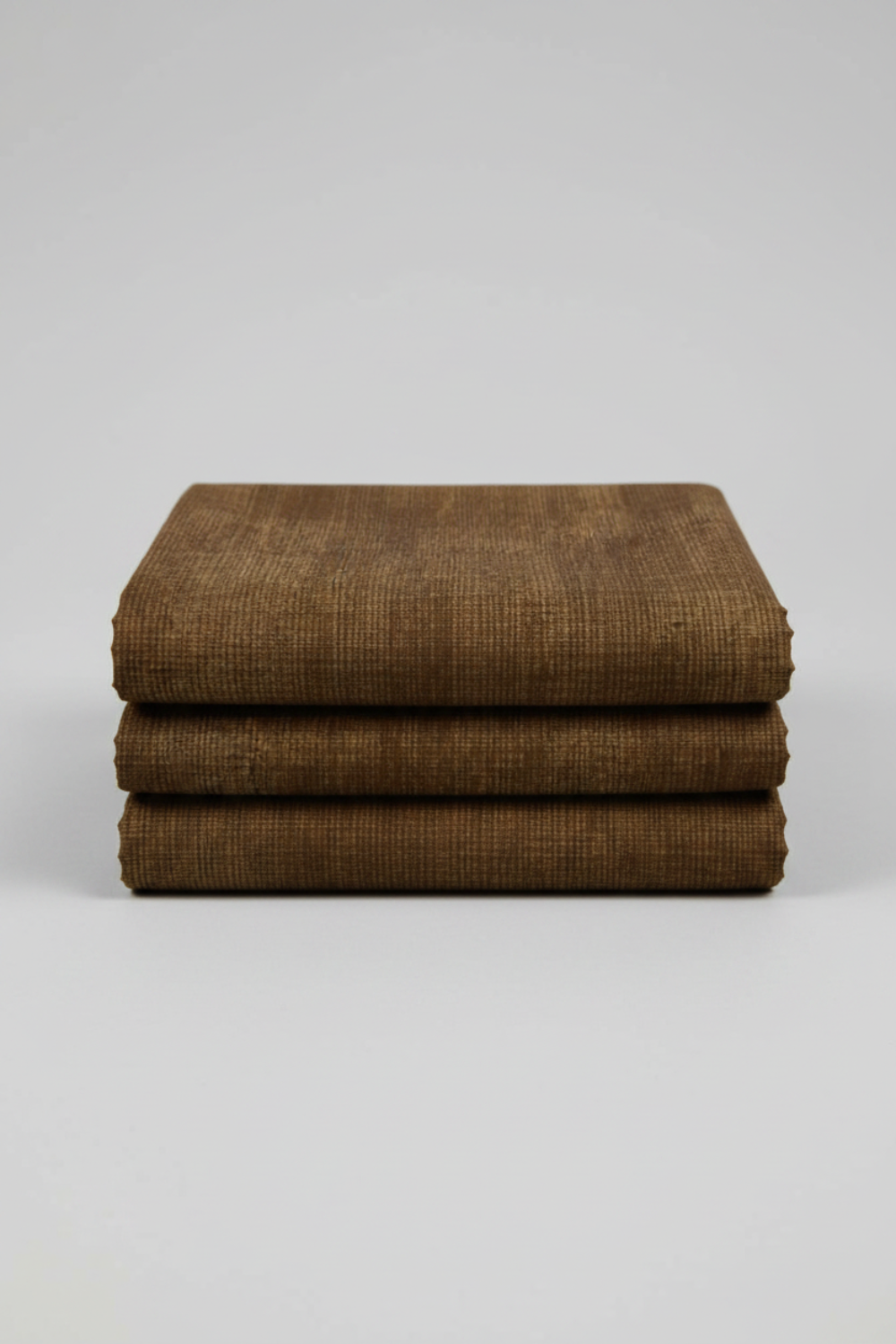 Folded Interwoven Brown quilting cotton fabric on a light grey background – by Jason Yenter for In The Beginning Fabrics. Shop at IraRobi Quilts | #brownfabric #interwoven #quiltingfabric #neutralfabric #blenderfabric