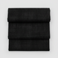 Folded Interwoven Charcoal quilting cotton fabric on a light grey background – by Jason Yenter for In The Beginning Fabrics. Shop at IraRobi Quilts | #charcoalfabric #interwoven #quiltingfabric #neutralfabric #blenderfabric