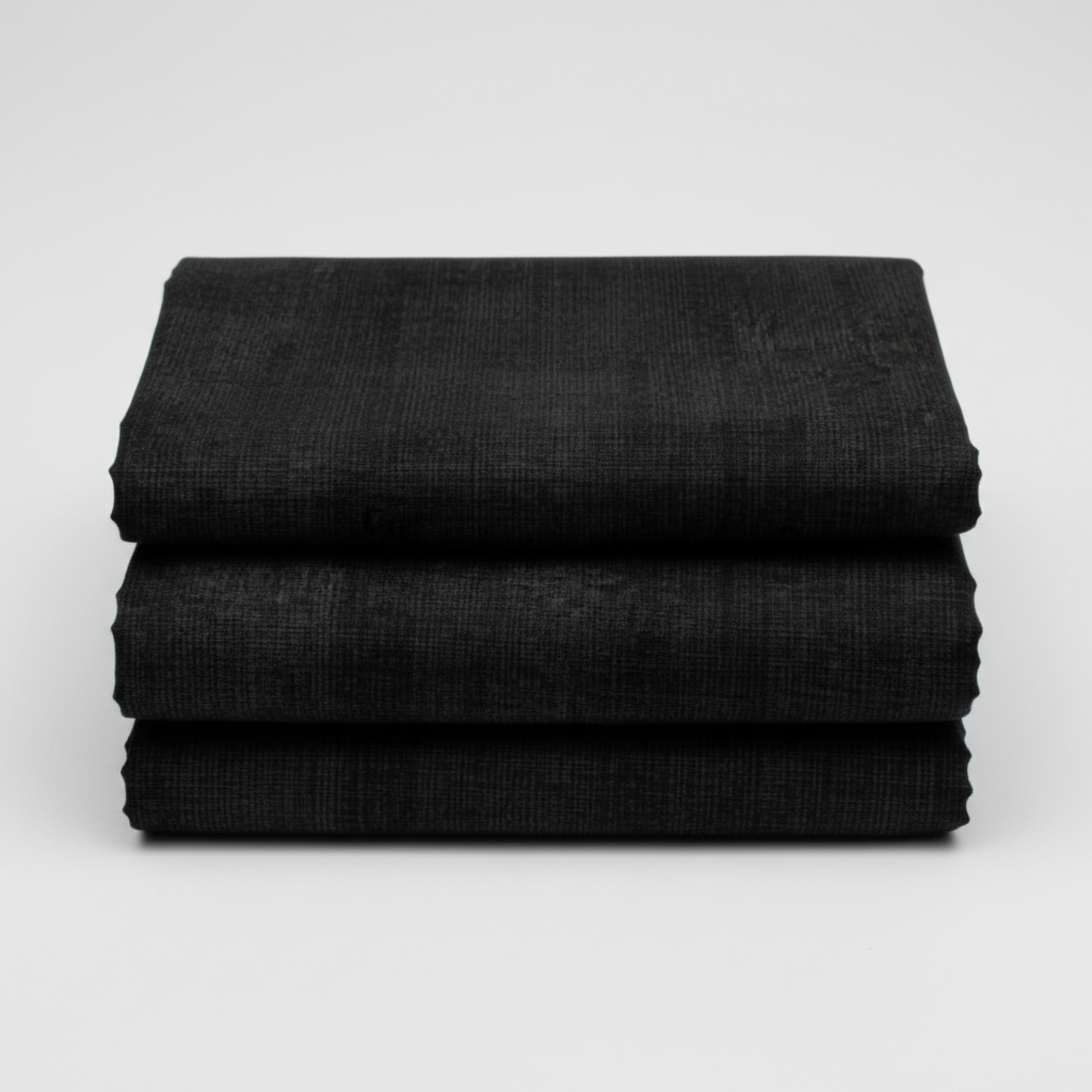Interwoven Charcoal quilting cotton fabric folded to show the deep grey-black geometric crosshatch print and texture – by Jason Yenter for In The Beginning Fabrics