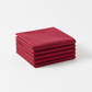 Interwoven Cherry Fabric by Jason Yenter for In The Beginning Fabrics — neatly folded fat quarter stack showing deep cherry red crosshatch texture print with subtle tonal shifts from vivid true red to deep burgundy-wine. Clean white surface, soft natural light. 100% cotton, 43–44" wide.