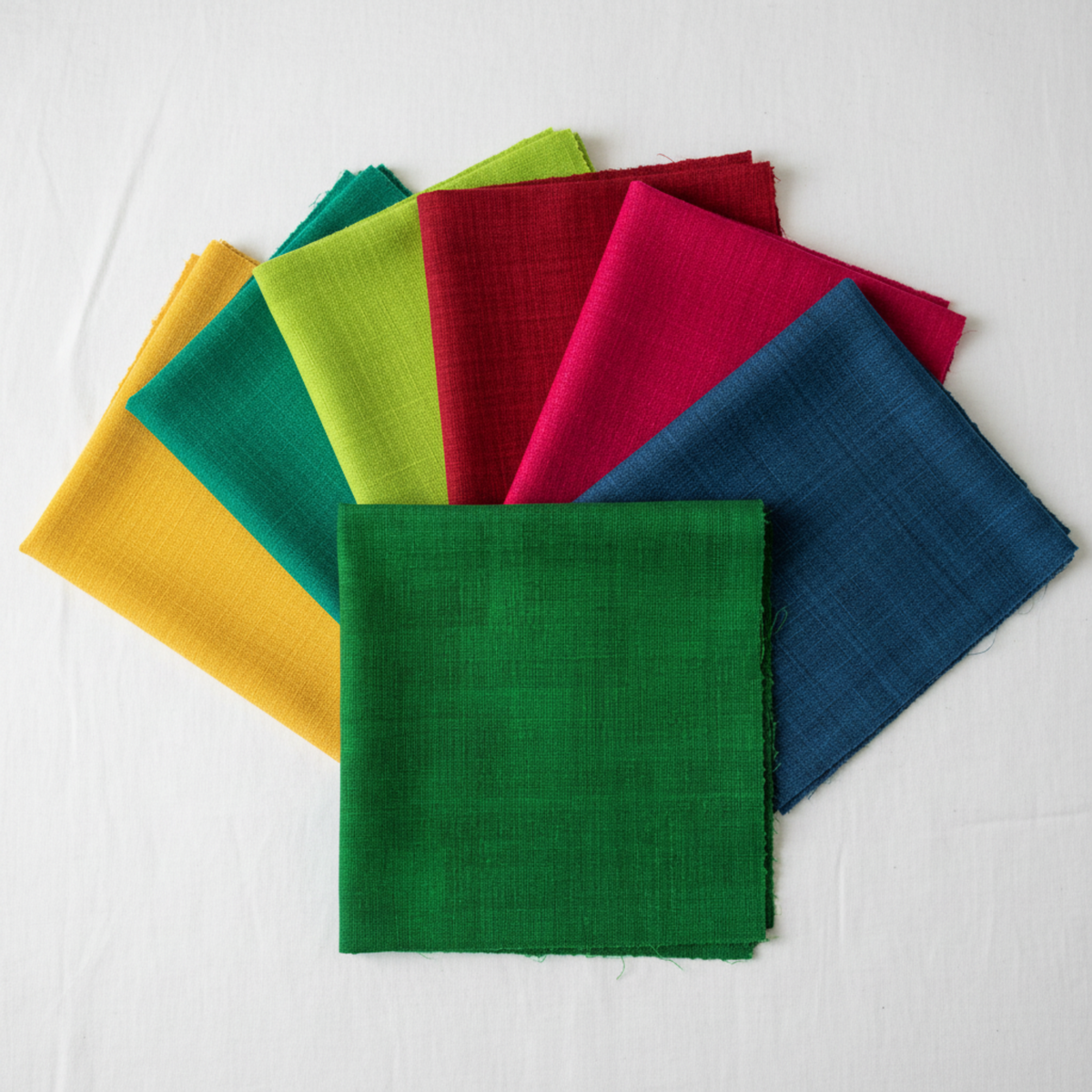 Interwoven Dark Green Fabric by Jason Yenter for In The Beginning Fabrics as the hero fabric in a coordination fan — deep forest green crosshatch tonal prominently in front, with coordinating Interwoven tonals fanned behind. 100% cotton, 43–44" wide.