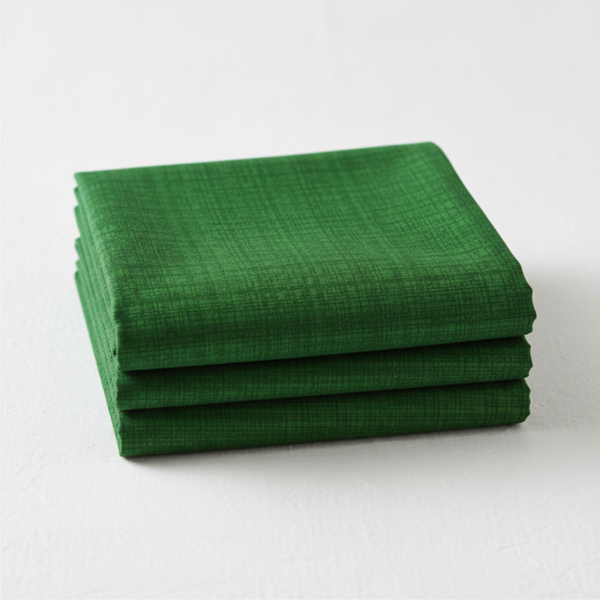 Interwoven Dark Green Fabric by Jason Yenter for In The Beginning Fabrics — neatly folded fat quarter showing deep dark green crosshatch texture with subtle hunter to forest green tonal shifts. Clean white surface, soft natural light. 100% cotton, 43–44" wide.