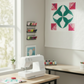 nterwoven Emerald Fabric by Jason Yenter for In The Beginning Fabrics featured in the curved petal shapes of a flower quilt block — vivid emerald green crosshatch tonal paired with hot pink polka dot, pink and red floral, and purple floral coordinating prints on a white background. Quilt blocks shown for inspiration. Coordinating fabrics and quilt patterns are available at IraRobi Quilts.