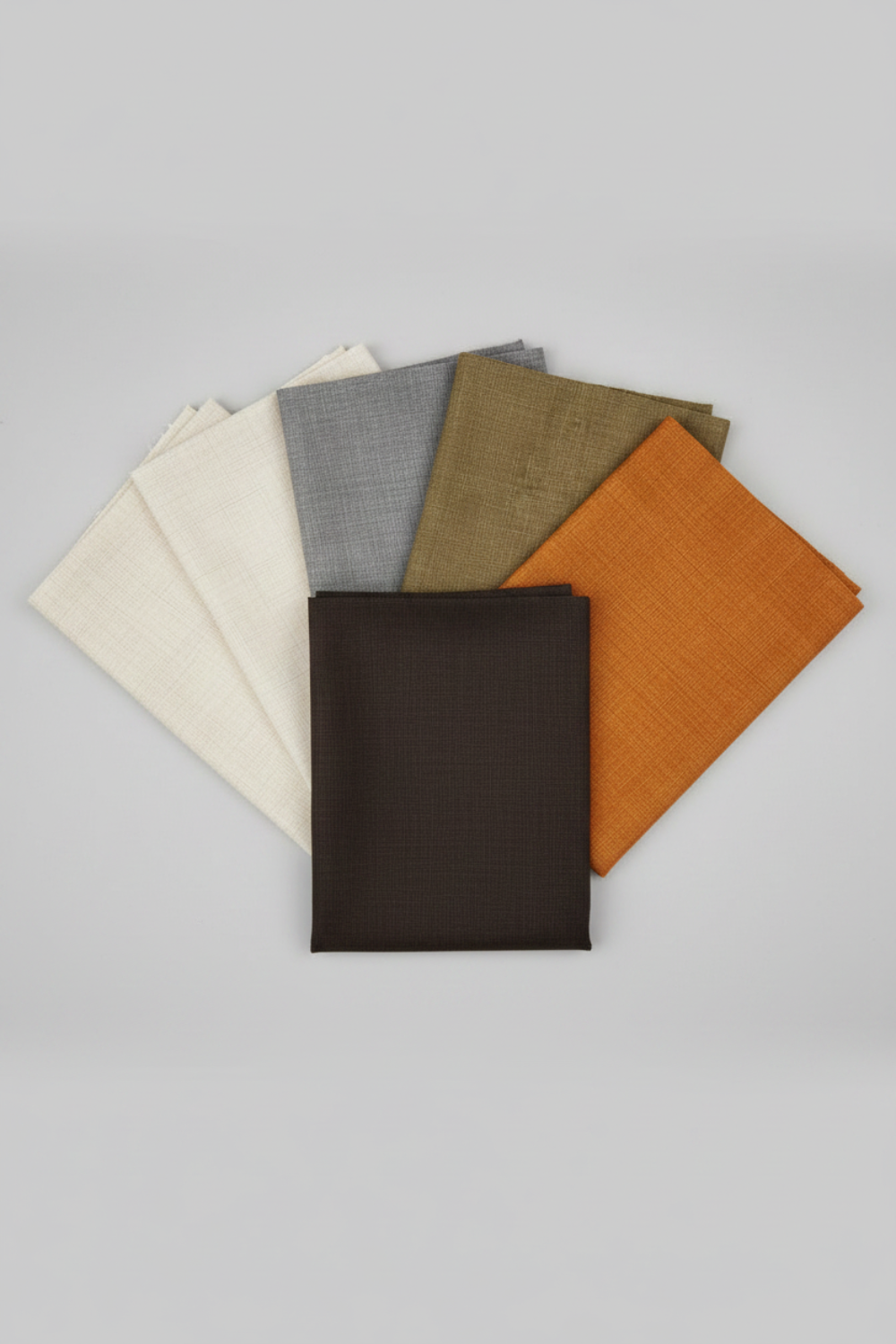 Interwoven Espresso Fabric by Jason Yenter for In The Beginning Fabrics fanned with coordinating crosshatch fabrics in taupe, olive, butterscotch, and pewter. Shop at IraRobi Quilts | #espressofabric #interwoven #quiltingfabric #darkfabric #crosshatchfabric