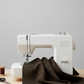 Near-black espresso brown quilting cotton fabric draped over a sewing machine in a clean quilting studio – Interwoven Espresso by Jason Yenter for In The Beginning Fabrics. Shop at IraRobi Quilts | #espressofabric #interwoven #quiltingfabric #darkfabric #modernquilt