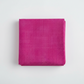 Interwoven Hot Pink Fabric by Jason Yenter for In The Beginning Fabrics — neatly folded fat quarter stack showing vivid hot pink crosshatch texture print with subtle tonal shifts from bright magenta-pink to deep fuchsia. Clean white surface, soft natural light. 100% cotton, 43–44" wide.