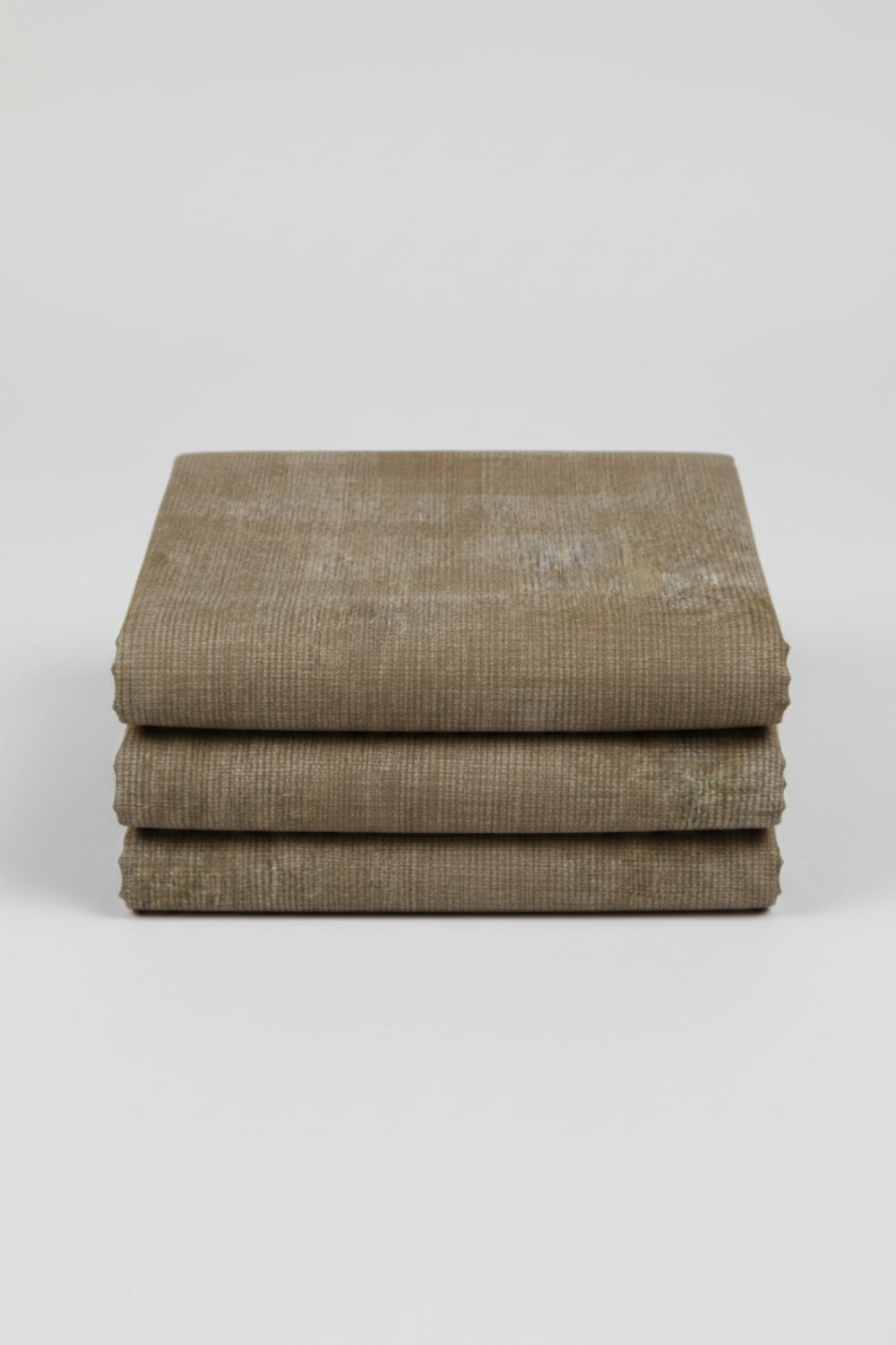 Folded Interwoven Olive quilting cotton fabric on a light grey background – by Jason Yenter for In The Beginning Fabrics. Shop at IraRobi Quilts | #olivefabric #interwoven #quiltingfabric #neutralfabric #blenderfabric