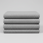 Folded Interwoven Pewter quilting cotton fabric on a light grey background – by Jason Yenter for In The Beginning Fabrics. Shop at IraRobi Quilts | #pewterfabric #interwoven #quiltingfabric #greyfabric #blenderfabric