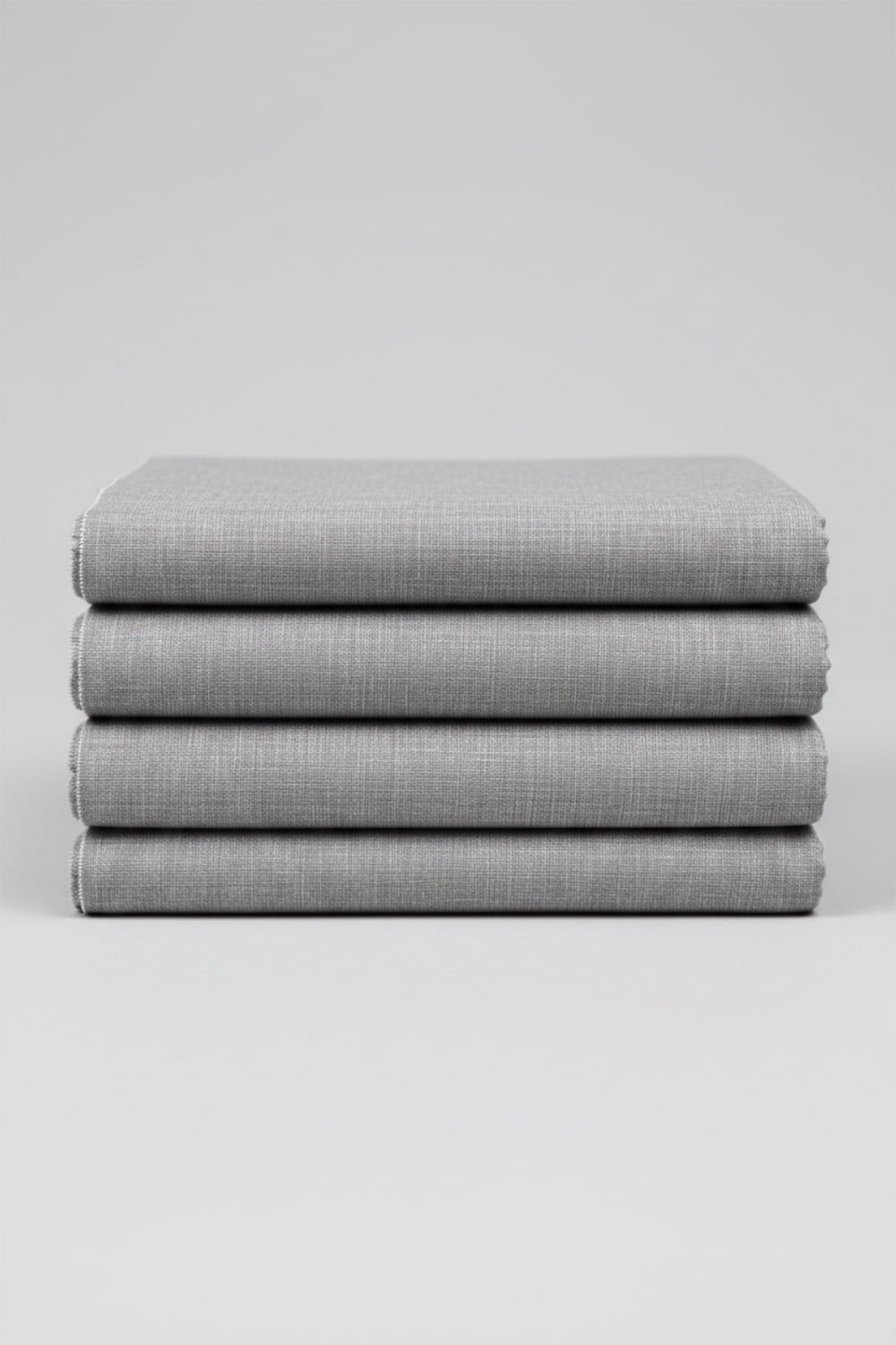 Folded Interwoven Pewter quilting cotton fabric on a light grey background – by Jason Yenter for In The Beginning Fabrics. Shop at IraRobi Quilts | #pewterfabric #interwoven #quiltingfabric #greyfabric #blenderfabric