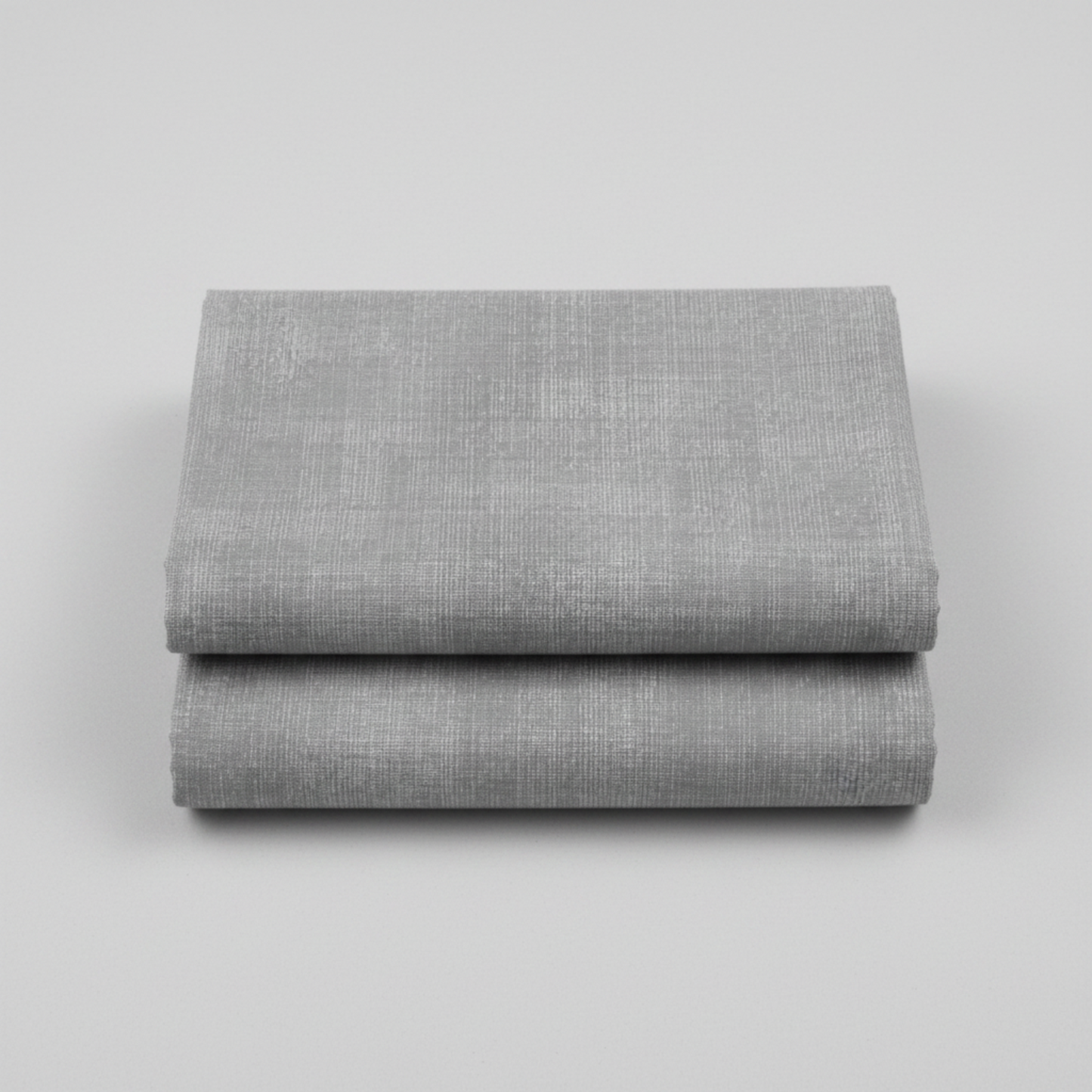 Interwoven Pewter Fabric by Jason Yenter for In The Beginning Fabrics folded to show the cool medium grey geometric crosshatch print and texture