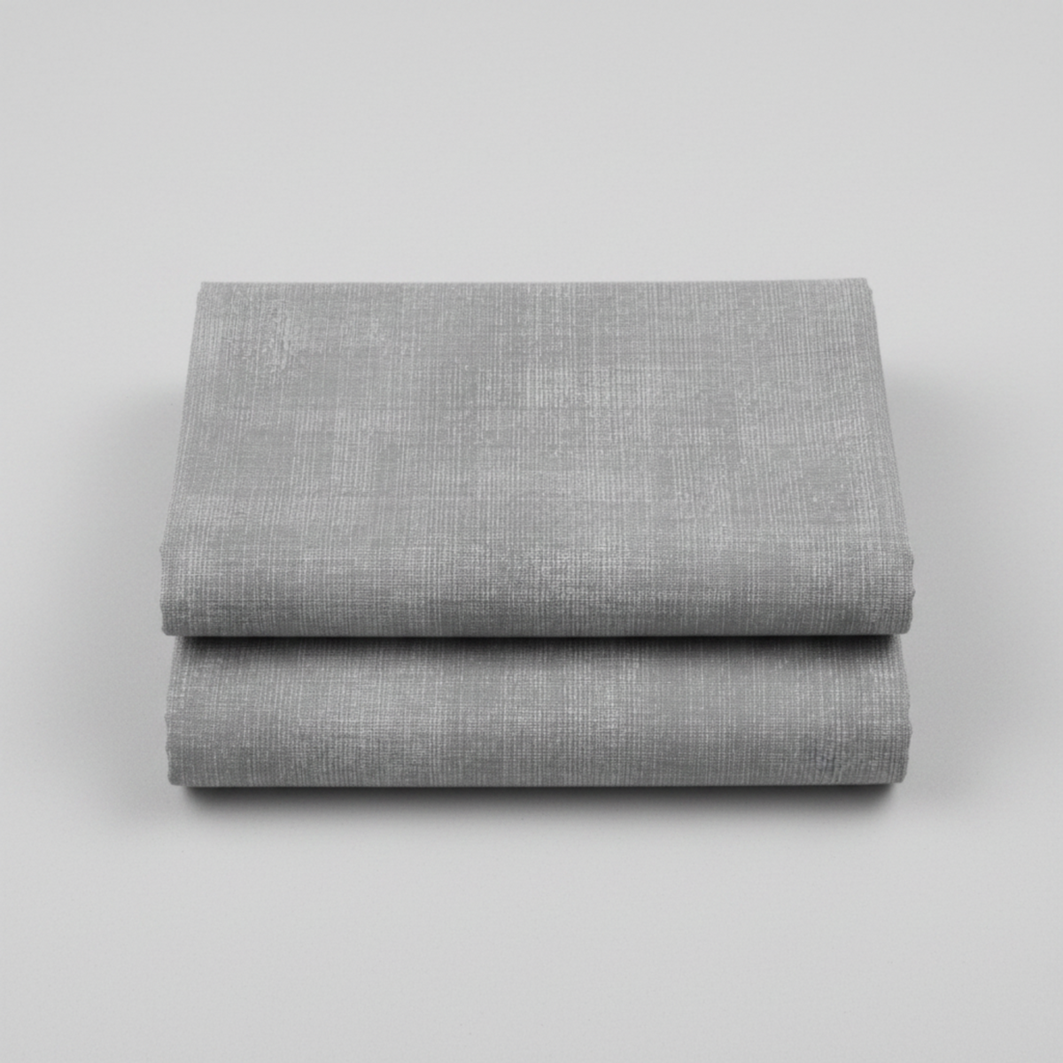 Interwoven Pewter Fabric by Jason Yenter for In The Beginning Fabrics folded to show the cool medium grey geometric crosshatch print and texture