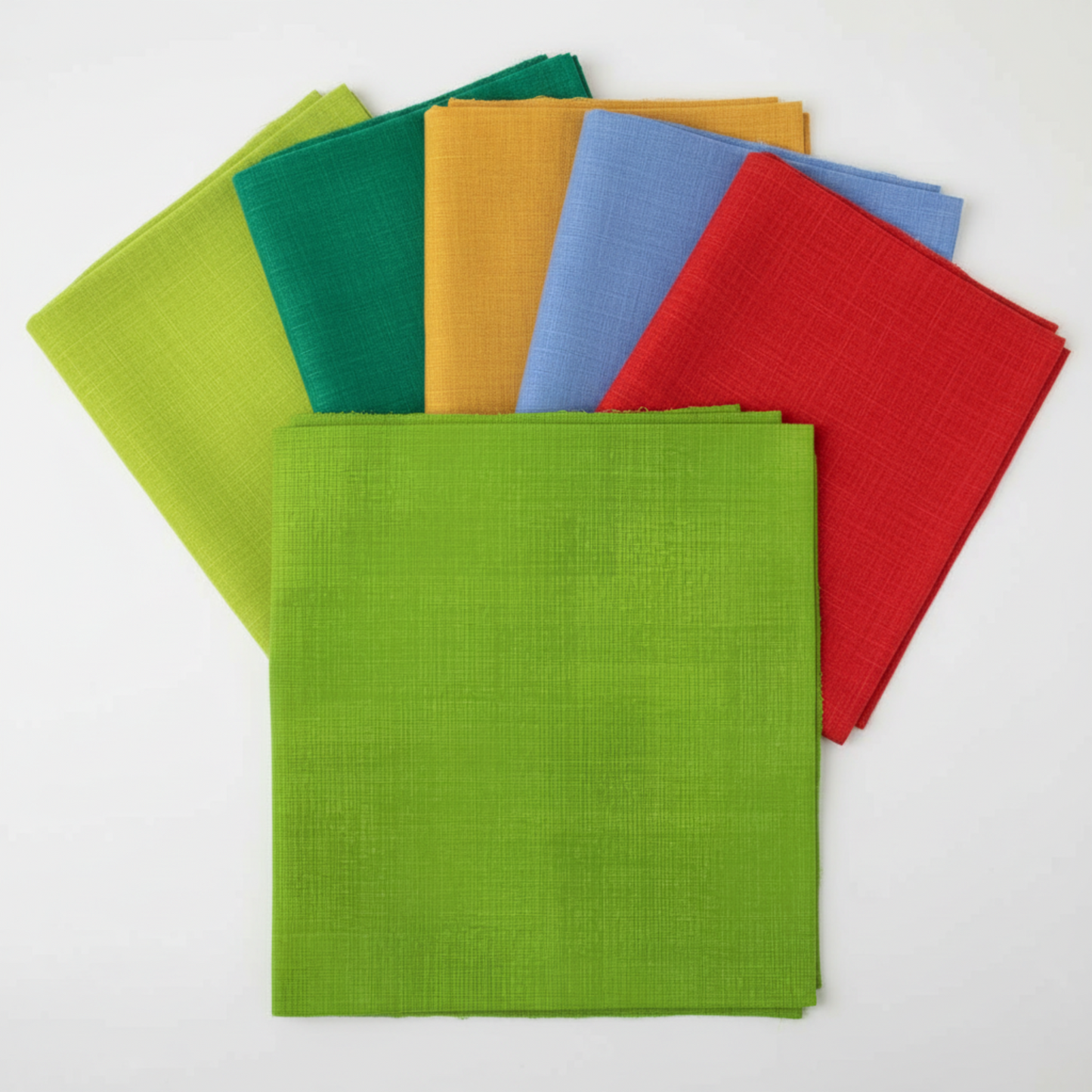 Interwoven Spring Grass Fabric by Jason Yenter for In The Beginning Fabrics as the hero fabric in an Interwoven coordination fan — fresh spring grass green crosshatch tonal prominently in front, with coordinating Interwoven tonals fanned behind. 100% cotton, 43–44" wide.