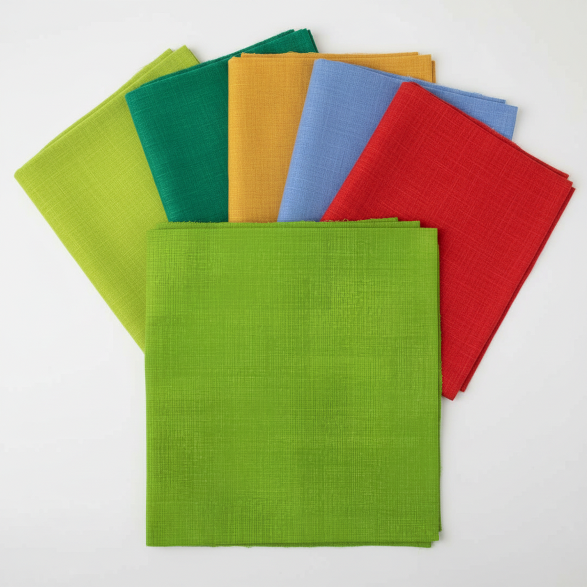 Interwoven Spring Grass Fabric by Jason Yenter for In The Beginning Fabrics as the hero fabric in an Interwoven coordination fan — fresh spring grass green crosshatch tonal prominently in front, with coordinating Interwoven tonals fanned behind. 100% cotton, 43–44" wide.