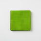 Interwoven Spring Grass Fabric by Jason Yenter for In The Beginning Fabrics — neatly folded fat quarter showing fresh spring grass green crosshatch texture with subtle yellow-green to meadow green tonal shifts. Clean white surface, soft natural light. 100% cotton, 43–44" wide.