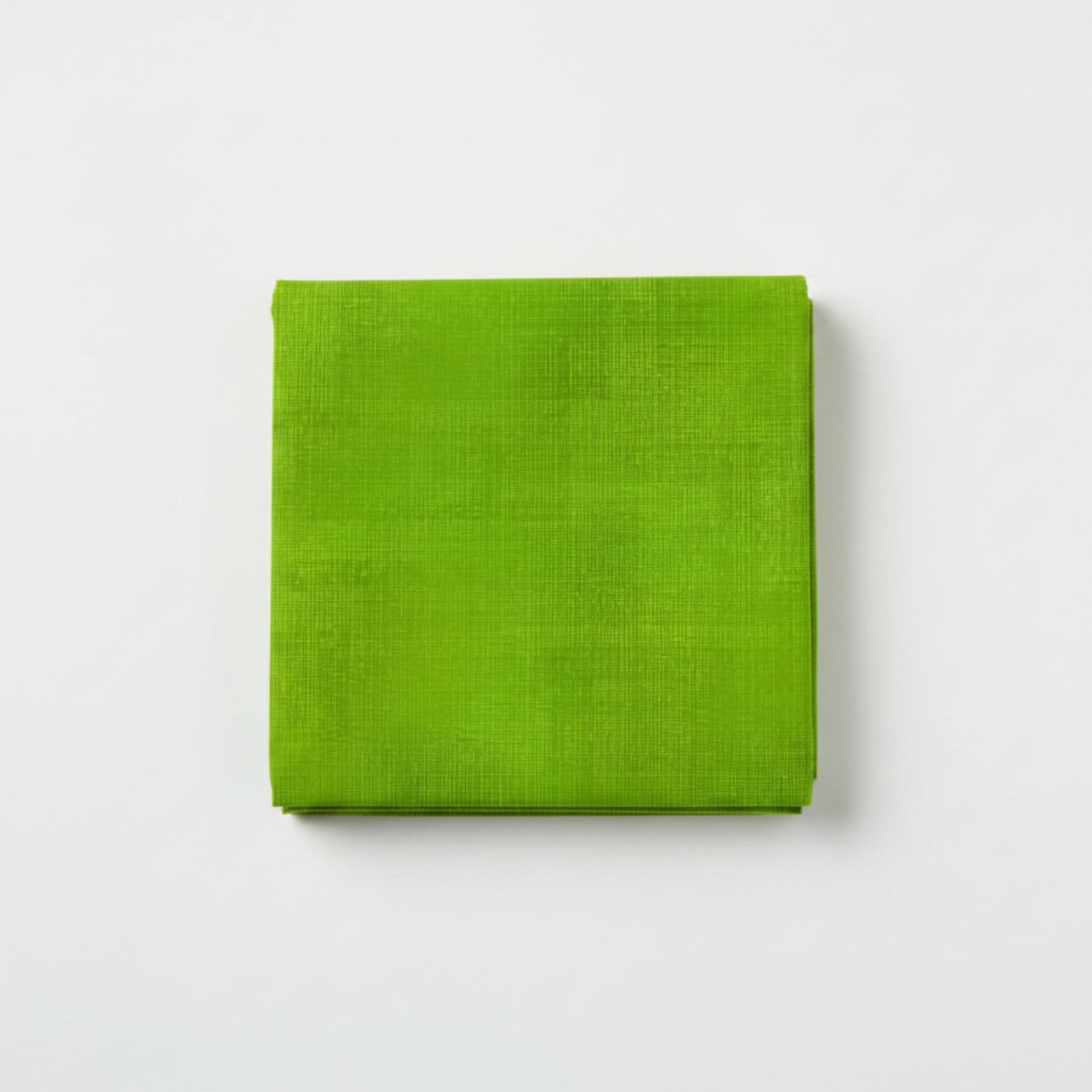 Interwoven Spring Grass Fabric by Jason Yenter for In The Beginning Fabrics — neatly folded fat quarter showing fresh spring grass green crosshatch texture with subtle yellow-green to meadow green tonal shifts. Clean white surface, soft natural light. 100% cotton, 43–44" wide.