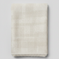 Interwoven Taupe Fabric by Jason Yenter for In The Beginning Fabrics — soft cream and taupe linen-look crosshatch blender quilting cotton folded vertically showing pattern detail, raw cut edges, light grey background, 100% cotton, 43–44" wide