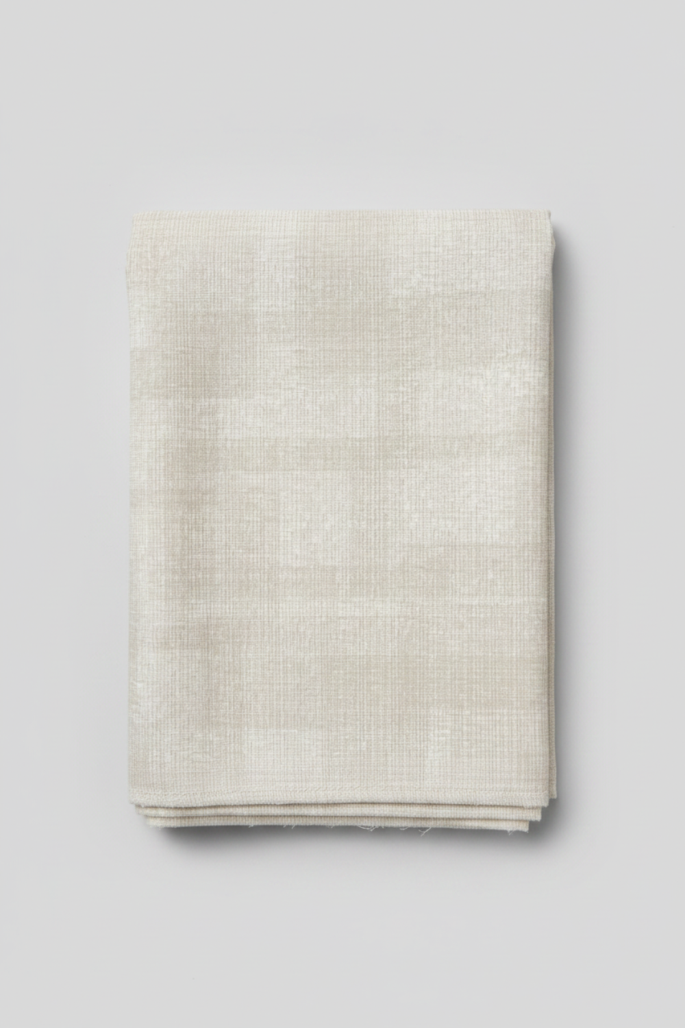 Interwoven Taupe Fabric by Jason Yenter for In The Beginning Fabrics — soft cream and taupe linen-look crosshatch blender quilting cotton folded vertically showing pattern detail, raw cut edges, light grey background, 100% cotton, 43–44" wide
