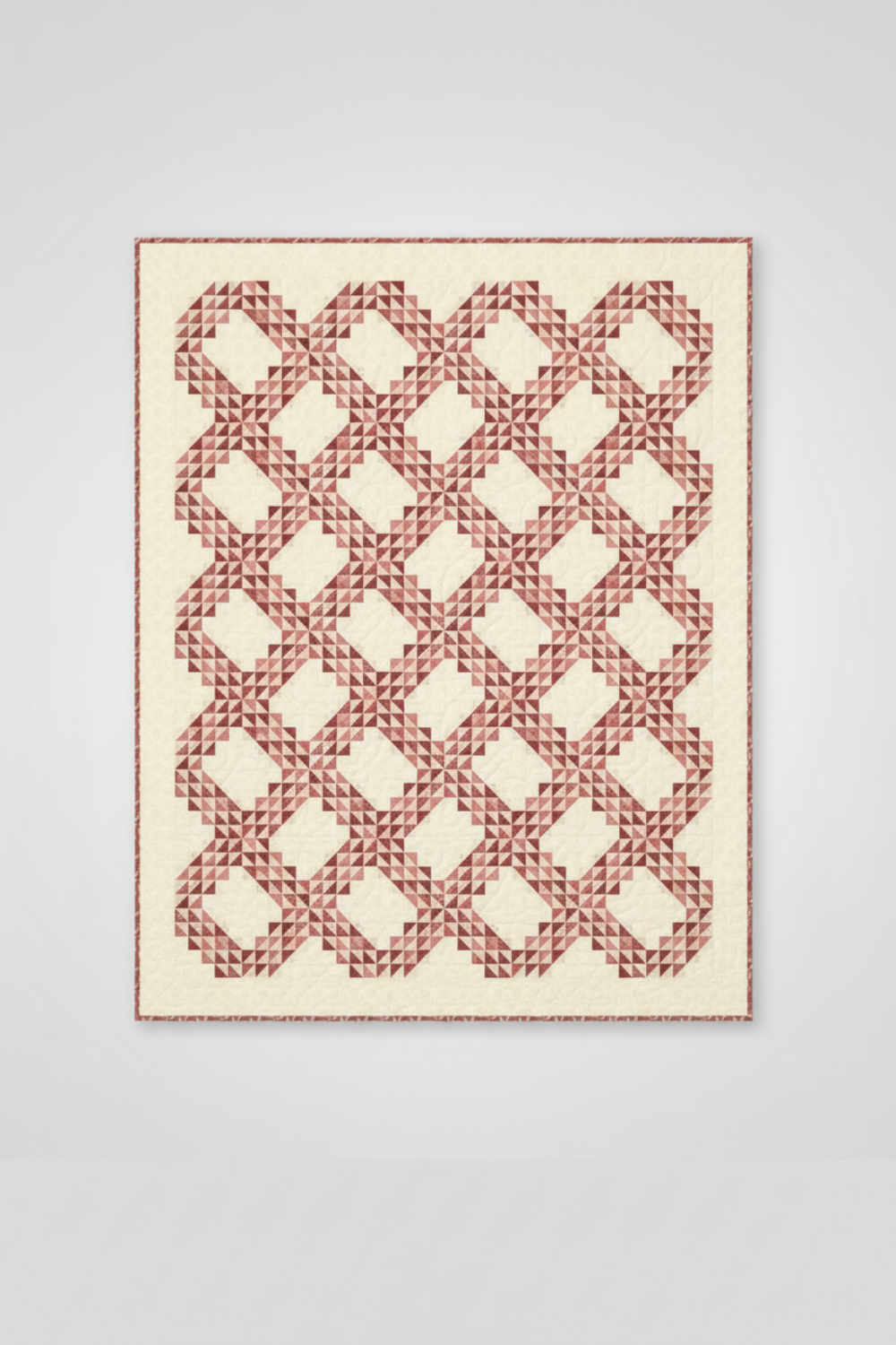 Fox Homestead Pink Leaves and Berries Fabric by Stacy West for Henry Glass — vertical view of the Kelley Quilt Pattern by Edyta Sitar, interlocking chain half-square triangle design in dusty rose and terracotta tones on a cream background. Quilts shown for inspiration feature the Kelley Quilt Pattern by Edyta Sitar — available at IraRobi Quilts.
