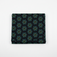 Folded swatch (1:1 — Shopify): La Luna Black Bursts quilting cotton fabric folded to show allover geometric star burst blender with large six-pointed star and snowflake bursts formed by rows of glowing hexagonal dots in teal, aqua, chartreuse, and soft lavender on deep black by Jason Yenter for In The Beginning Fabrics, 100% cotton, 3 yard cut