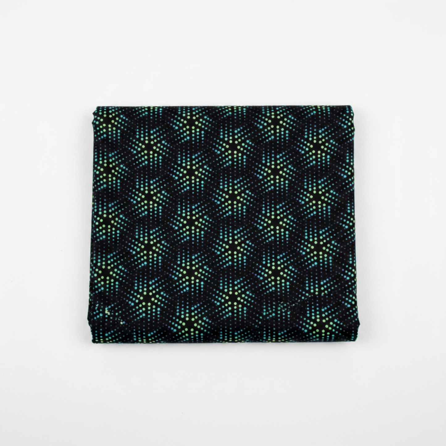 Folded swatch (1:1 — Shopify): La Luna Black Bursts quilting cotton fabric folded to show allover geometric star burst blender with large six-pointed star and snowflake bursts formed by rows of glowing hexagonal dots in teal, aqua, chartreuse, and soft lavender on deep black by Jason Yenter for In The Beginning Fabrics, 100% cotton, 3 yard cut