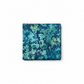 La Luna Teal Leaves quilting cotton fabric folded to show dense allover tonal leaf silhouette print – overlapping fern fronds, maple leaves, and botanical sprigs in aqua, teal, chartreuse, and deep navy on rich cobalt and teal watercolor wash by Jason Yenter for In The Beginning Fabrics, 100% cotton, 3 yard cut