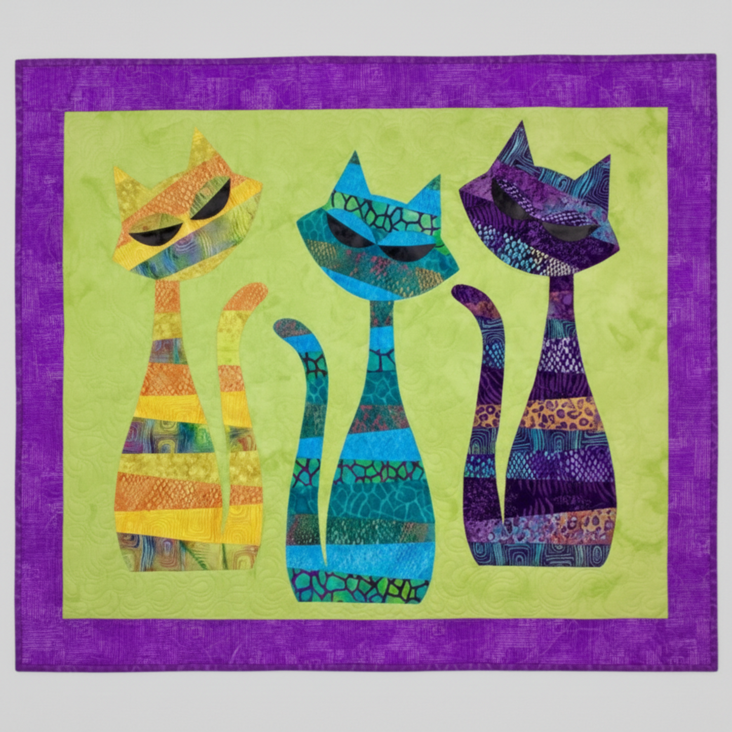 ModCat quilt with Interwoven Plum by Jason Yenter for In The Beginning Fabrics as the border fabric – three colorful cat appliqués on lime green center panel, ModCat Quilt Pattern by Colourwerx