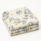 Folded Celestial News Dropping Moonbeam fabric by Zen Chic for Moda Fabrics, featuring charcoal newsprint motifs and mustard-gold dots on ivory.