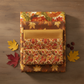 Autumn Celebration Multi Circles fabric by Jason Yenter coordinated with Autumn Celebration collection fabrics — tonal golden amber blender, small leaf print, and brown maple leaves. Rich harvest palette for fall quilting projects. In The Beginning Fabrics, 100% cotton.