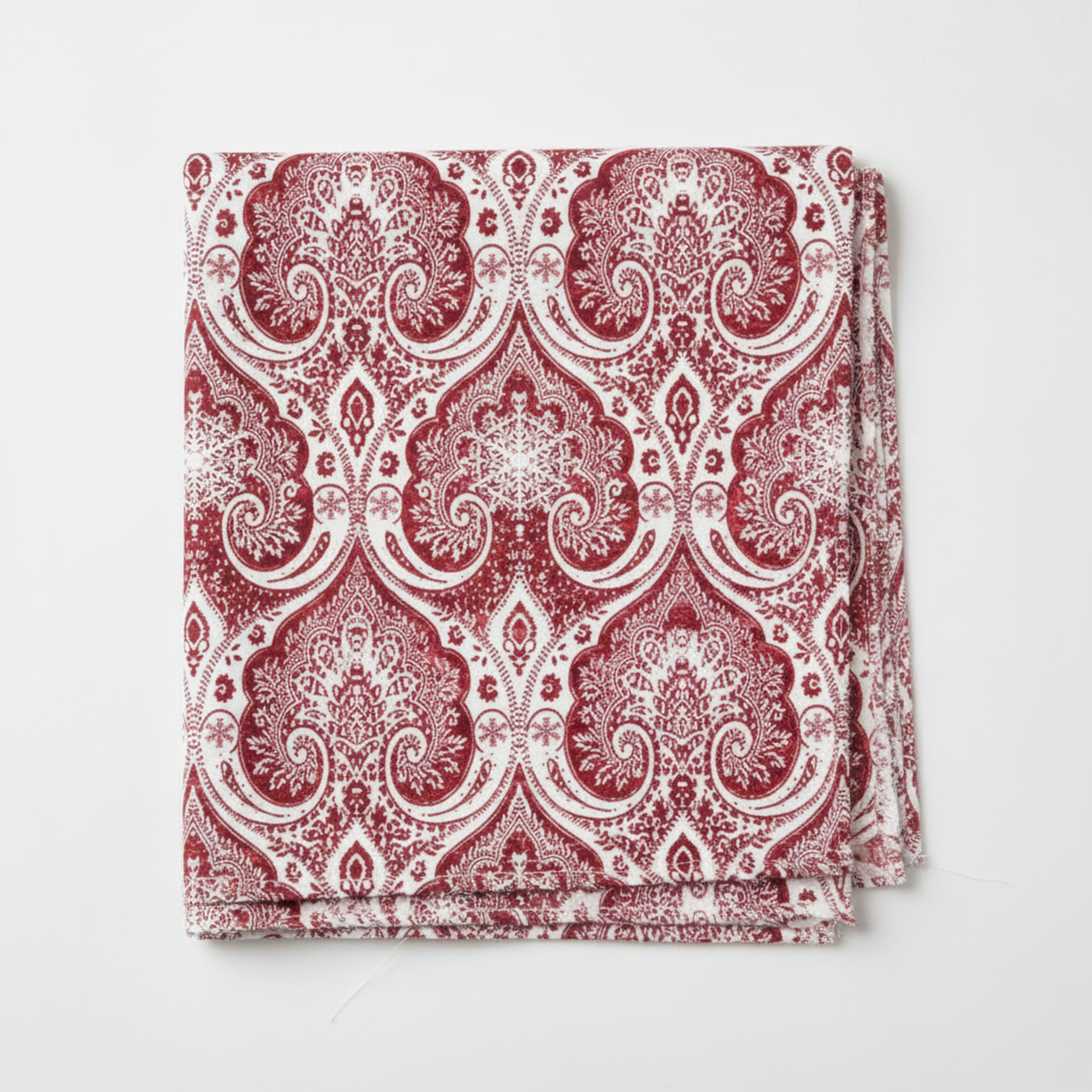 Nature's Winter Red Snowflake Ogee quilting cotton by Jason Yenter for In The Beginning Fabrics — folded fat quarter on a white surface showing bold white ogee lattice with intricate snowflake medallions and swirling paisley scrolls on mottled crimson and burgundy. 100% cotton, 43–44" wide.