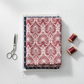 Nature's Winter Red Snowflake Ogee quilting cotton by Jason Yenter for In The Beginning Fabrics — folded as hero on a coordinating fabric stack with silver scissors and deep red thread spools on a white surface. Coordinating fabrics and quilt patterns available at IraRobi Quilts.