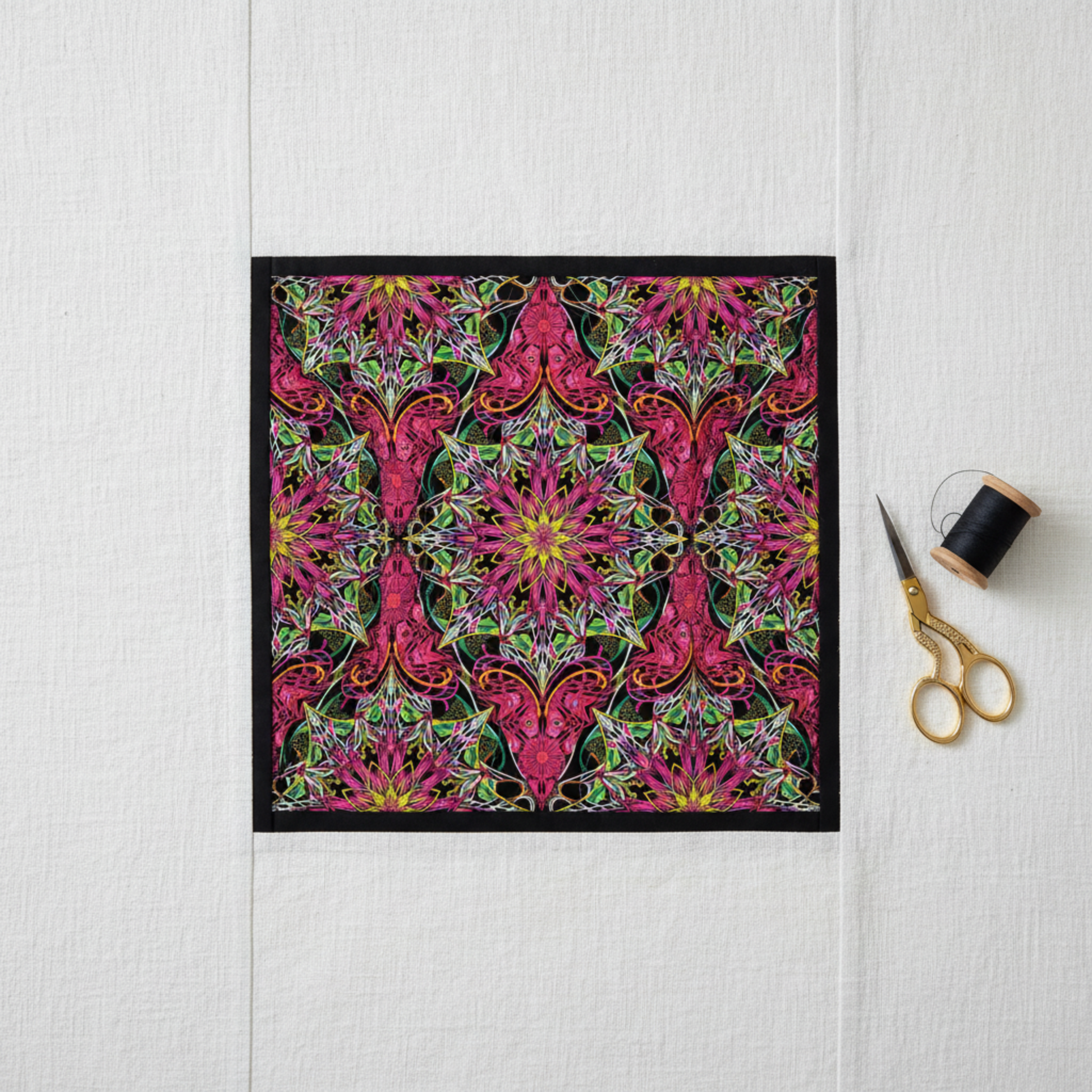 Fussy-cut medallion quilt center block featuring Needle Stars Byzantium Red/Multi by Paula Nadelstern for Benartex, with the kaleidoscopic star centered and framed by solid black and magenta borders. Quilt blocks shown for inspiration. Coordinating fabrics and quilt patterns are available at IraRobi Quilts.