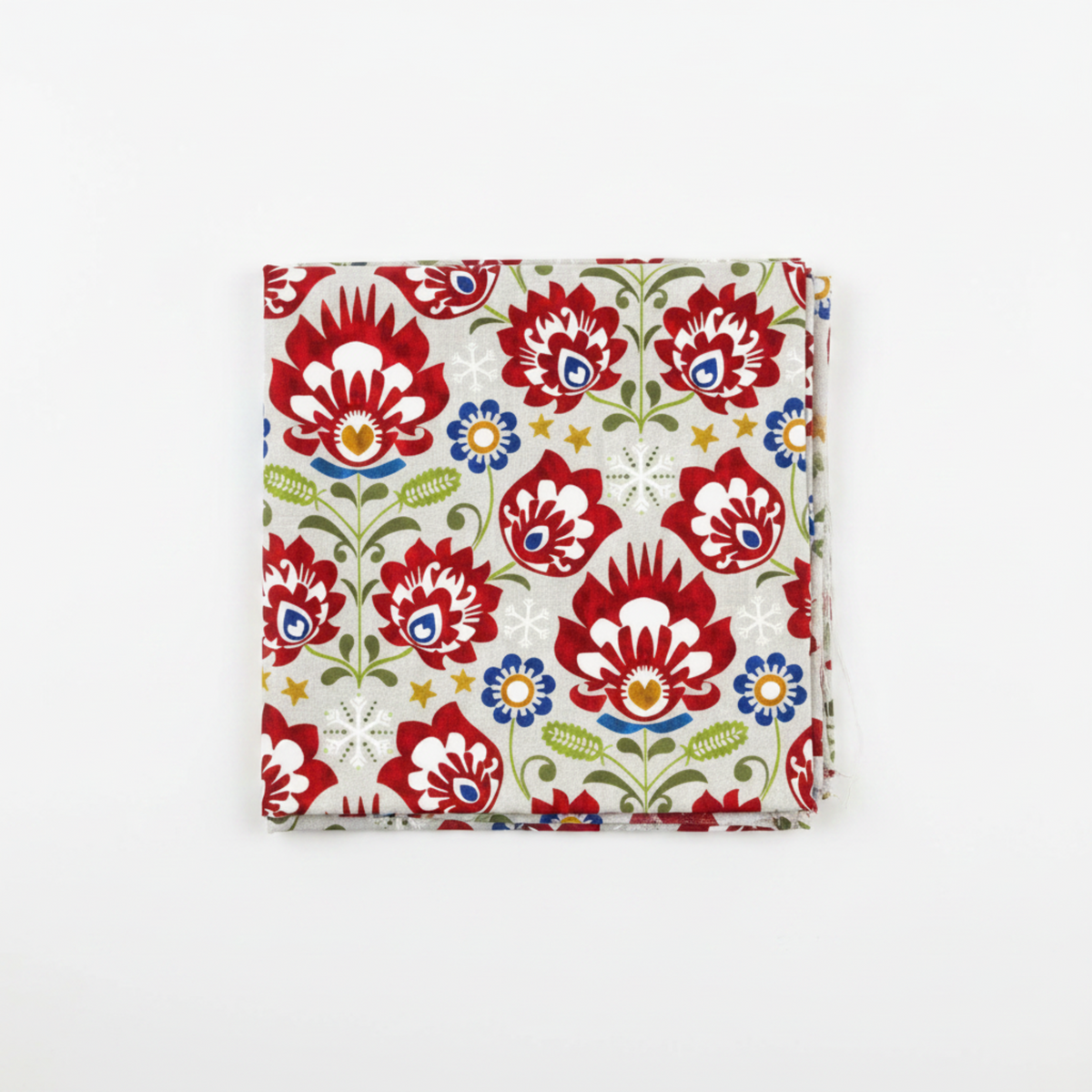 NYSNO New Snow Multicolor Floral quilting cotton by Jason Yenter for In The Beginning Fabrics — folded fat quarter on a white surface showing oversized bold folk-art florals in crimson red with white petal cutwork, cobalt blue accent flowers with gold centers, olive green stems, white snowflakes, and gold stars on soft mottled light grey. 100% cotton, 43–44" wide.