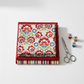 NYSNO New Snow Multicolor Floral quilting cotton by Jason Yenter for In The Beginning Fabrics — folded as hero on a coordinating fabric stack with silver scissors and thread spools on a white surface. Coordinating fabrics and quilt patterns available at IraRobi Quilts
