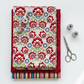 NYSNO New Snow Multicolor Floral quilting cotton by Jason Yenter for In The Beginning Fabrics — vertical flat lay folded as hero on a coordinating fabric stack with silver scissors and thread spools on a white surface. Coordinating fabrics and quilt patterns available at IraRobi Quilts.