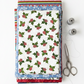 NYSNO New Snow White Holly quilting cotton by Jason Yenter for In The Beginning Fabrics — vertical flat lay folded as the hero on a tall stack of coordinating winter fabrics with silver thread spools and silver scissors on a white surface. Coordinating fabrics and quilt patterns available at IraRobi Quilts.