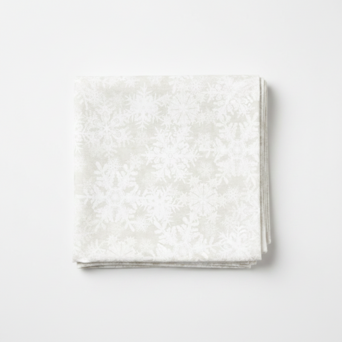 NYSNO New Snow White Snowflakes quilting cotton by Jason Yenter for In The Beginning Fabrics — folded fat quarter on a white surface showing densely scattered white-on-white snowflake silhouettes on a soft mottled ground, tone-on-tone allover print, 100% cotton, 43–44" wide.