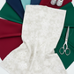NYSNO New Snow White Snowflakes quilting cotton by Jason Yenter for In The Beginning Fabrics — yardage draped as the front hero over a circular fan of coordinating fabrics in forest green, crimson, navy, teal, and dark green, with silver thread spools and silver scissors on a white surface. Coordinating fabrics and quilt patterns available at IraRobi Quilts.